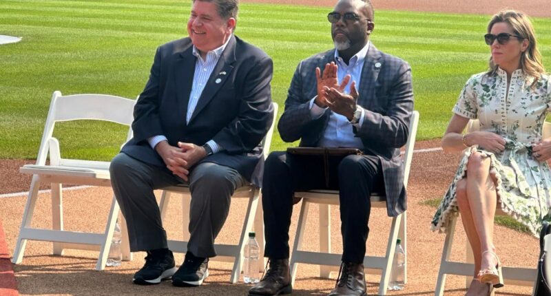 Illinois Gov. JB Pritzker, left, and Chicago mMyor Brandon Johnson listen during a baseball news conference, Friday, Aug. 1, 2025, in Chicago, announcing that the Chicago Cubs' Wrigley Field will host the 2027 All-Star Game. (AP Photo/Andrew Seligman)