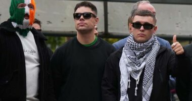 Liam Óg Ó hAnnaidh, aka Mo Chara, right, a member of the Irish language band Kneecap, celebrates as he leaves Woolwich Crown Court in London, Friday, Sept. 26, 2025, after Chief Magistrate, Senior District Judge Paul Goldspring, dismissed a terrorism offence relating to displaying a flag in support of Hezbollah during a performance with the band in November 2024, on a technical error.