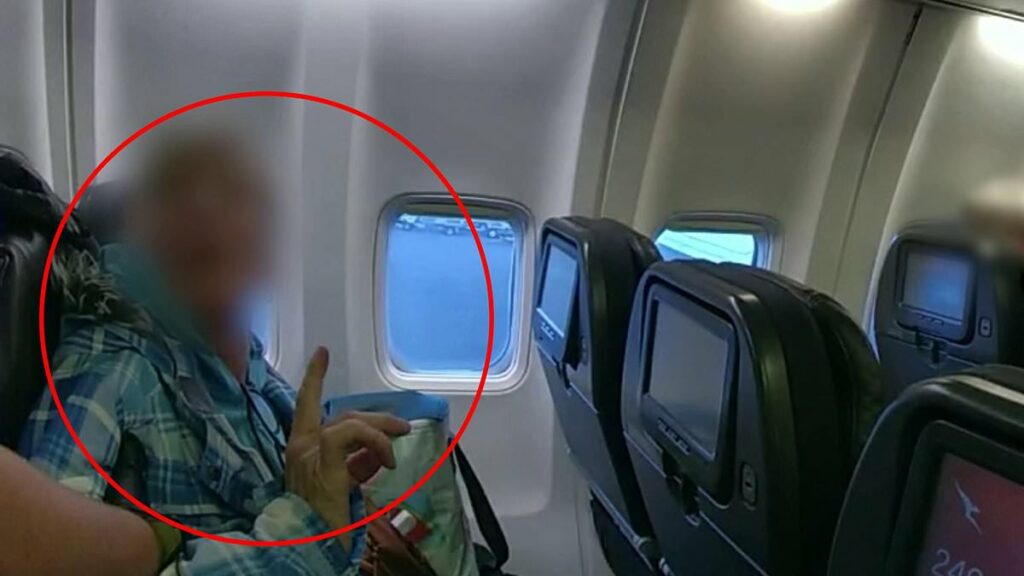 Dramatic moment cops board a Qantas flight and arrest a passenger - after alleged act forces plane to turn back before it even took off