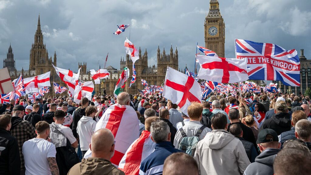 Elgar on a ghetto blaster. A sea of flags and tributes to Charlie Kirk. VERY rude chants about Keir. Then the bottles and fists began to fly... IAN GALLAGHER attends the 110,000-strong 'Unite the Kingdom' march in London