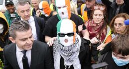 Hezbollah flag-waving Kneecap rapper has terror charge thrown out thanks to blundering CPS as his group's fans create circus at court