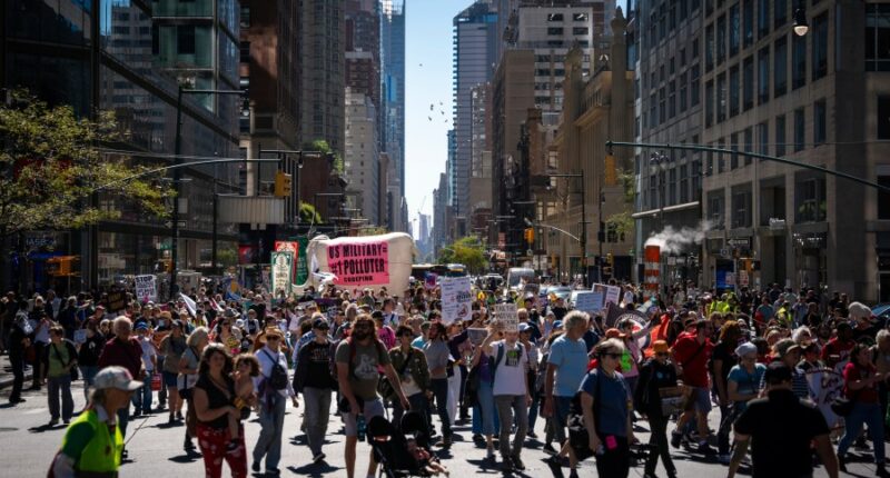 Marchers gather in worldwide protest of financial institutions 'profiting off the climate crisis'
