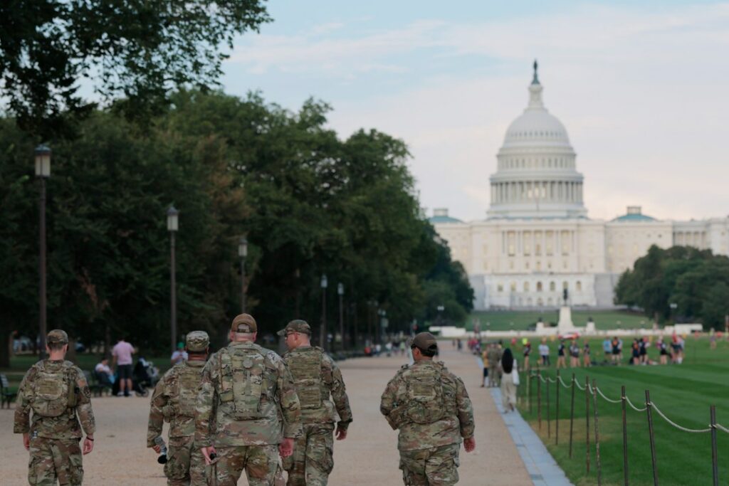 members of the National Guard walk on the National Mall