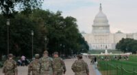 members of the National Guard walk on the National Mall