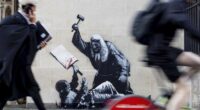 A photo released by Banksy of the new artwork by the artist which portrays a judge beating a protester with a gavel at the Royal Courts of Justice in London.