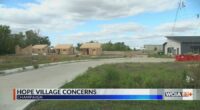 Residents outside of Hope Village asking for changes in the project