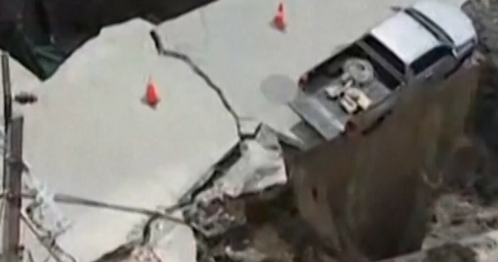 Sinkhole swallows vehicle and electrical poles
