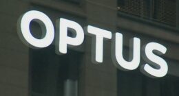 A close-up shot of an Optus store sign