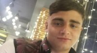 Thug who beat his girlfriend so bad she lost her unborn child is jailed - and was seen smiling as he was led to the cells