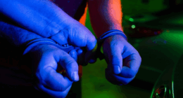 Two hands in police handcuffs.