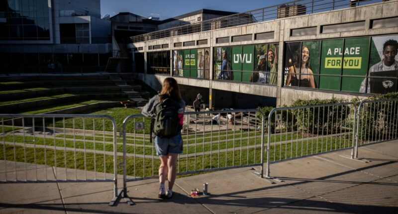 A person looks over the Utah Valley University courtyard