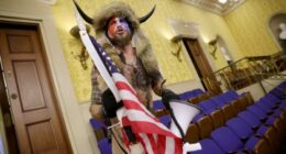 ‘QAnon shaman,’ who was pardoned by Trump, is now suing him