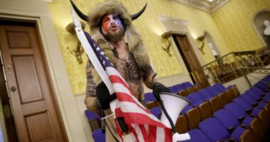 ‘QAnon shaman,’ who was pardoned by Trump, is now suing him
