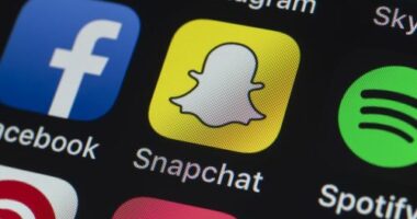 London, UK - July 19, 2018: The buttons of Instagram, Skype, Pinterest, Spotify, Snapchat Facebook and other apps on the screen of an iPhone.