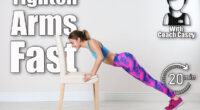 Young woman exercising with chair near white wall. Home fitness. 6 Bodyweight Exercises That Erase Bat Wings Better Than Tricep Dips After 50. Cover