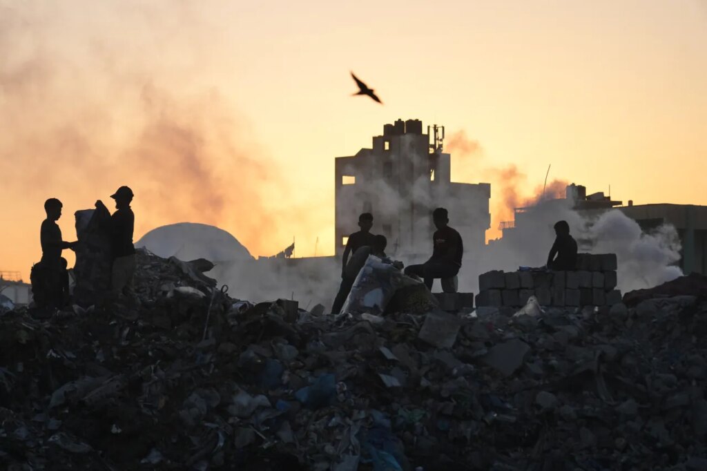 Palestinians search for firewood and plastic at a landfill in Gaza City Saturday, Oct. 25, 2025. (AP Photo/Abdel Kareem Hana)