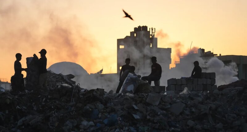 Palestinians search for firewood and plastic at a landfill in Gaza City Saturday, Oct. 25, 2025. (AP Photo/Abdel Kareem Hana)