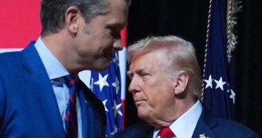 President Donald Trump is greeted by Secretary of Defense Pete Hegseth before speaking to a gathering of top U.S. military commanders at Marine Corps Base Quantico, Tuesday, Sept. 30, 2025, in Quantico, Va. (AP Photo/Evan Vucci)