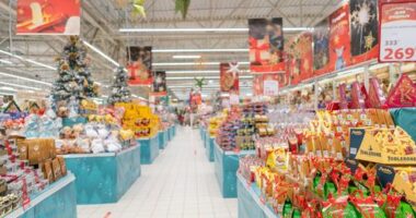 Christmas decorations line a supermarket.