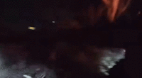 gif of officers bashing car window with baton as fire engulfs vehicle
