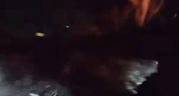 gif of officers bashing car window with baton as fire engulfs vehicle
