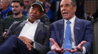 New York City Mayor Eric Adams and Independent candidate former New York Gov. Andrew Cuomo, right, speak during the second half of an NBA basketball game between the New York Knicks and the Cleveland Cavaliers Wednesday, Oct. 22, 2025, at Madison Square Garden in New York. (AP Photo/Frank Franklin II)