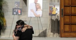 FILE - Mourners embrace during a memorial for Los Angeles Angels pitcher Tyler Skaggs at the St. Monica Catholic Church, July 22, 2019, in Los Angeles. (AP Photo/Marcio Jose Sanchez, File)