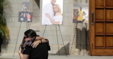 FILE - Mourners embrace during a memorial for Los Angeles Angels pitcher Tyler Skaggs at the St. Monica Catholic Church, July 22, 2019, in Los Angeles. (AP Photo/Marcio Jose Sanchez, File)
