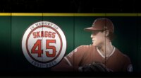 FILE - An image and logo memorializing former Los Angeles Angels pitcher Tyler Skaggs is displayed on the outfield wall in Anaheim, Calif., July 17, 2019. (AP Photo/Kyusung Gong, File)