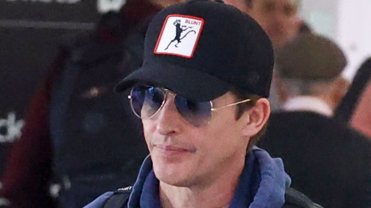 Guess who! Global superstar attempts to go incognito as he touches down in Sydney