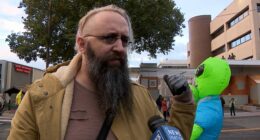 Brooks Brown with alien costume behind him