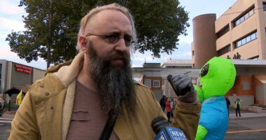 Brooks Brown with alien costume behind him