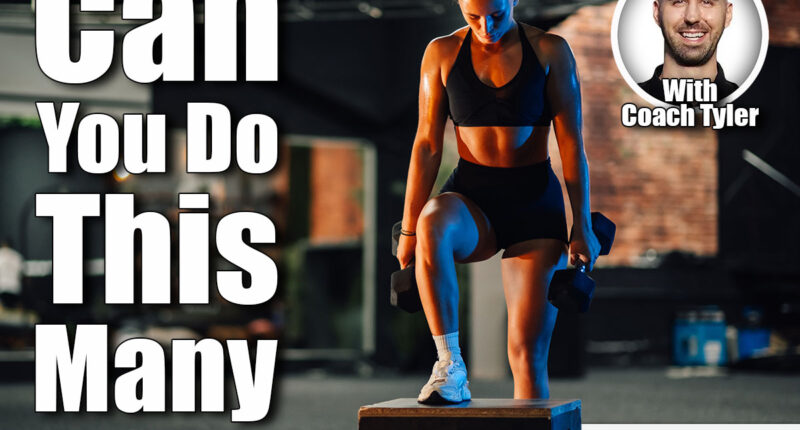 Young sportswoman lifting dumbbells while stepping up on a box at the gym. She is focused on her workout and determined to achieve her fitness goals. If You Can Do This Many Step-Ups in 60 Seconds After 50, Your Cardio Is Top-Tier. Cover