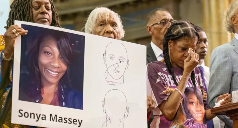 FILE - Donna Massey, center right, wipes tears from her face as she listens to Rev. Al Sharpton, right, speak during a press conference over the shooting death of her daughter Sonya, who was killed by Illinois sheriff