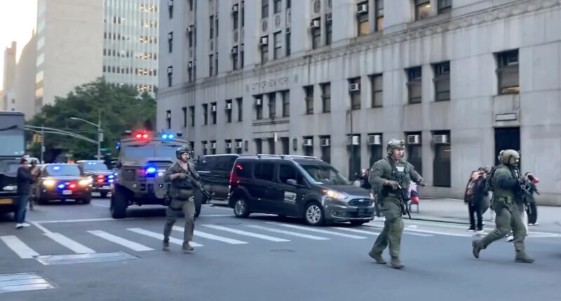 Federal agents walk down Lafayette Street as demonstrators follow along after an immigration sweep on Canal Street through Chinatown, Tuesday, Oct. 21, 2025, in New York. (AP Photo/Jake Offenhartz)