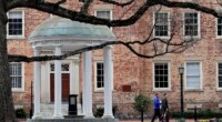FILE - People walk through University of North Carolina campus March 18, 2020, in Chapel Hill, N.C. (AP Photo/Gerry Broome, File)