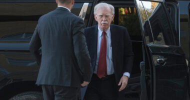 John Bolton arrives at court to surrender to authorities on charges in classified information case