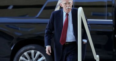 John Bolton, ex-Trump adviser, turns himself in on criminal charges