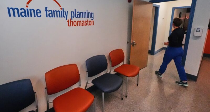 FILE - Vanessa Shields-Haas, a nurse practitioner, walks from the lobby toward the examination rooms at the Maine Family Planning healthcare facility, July 15, 2025, in Thomaston, Maine. (AP Photo/Charles Krupa, File)