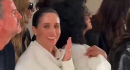 Meghan giggles as model 'stumbles on the catwalk'