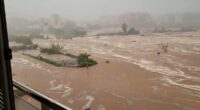 Moment roads become rivers as floodwaters sweep away cars in Spain - trapping the masses as ALL trains to and from country's biggest cities are cancelled