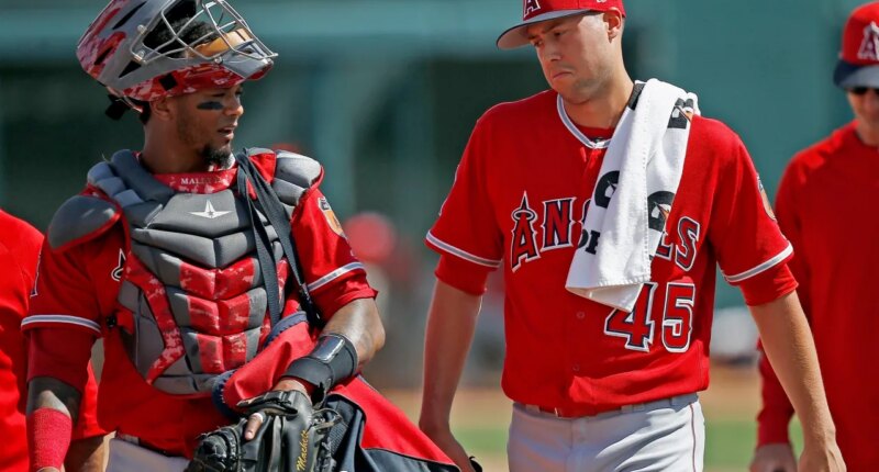 FILE - Los Angeles Angels starting pitcher Tyler Skaggs (45) talks with catcher Martin Maldonado, left, after warming up in the bullpen prior to a spring training baseball game against the Chicago White Sox, March 4, 2017, in Glendale, Ariz. (AP Photo/Ross D. Franklin, File)