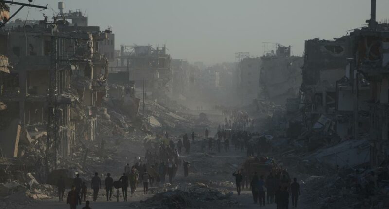 Palestinians return to ruins and US expects hostages freed on Monday as Gaza ceasefire holds