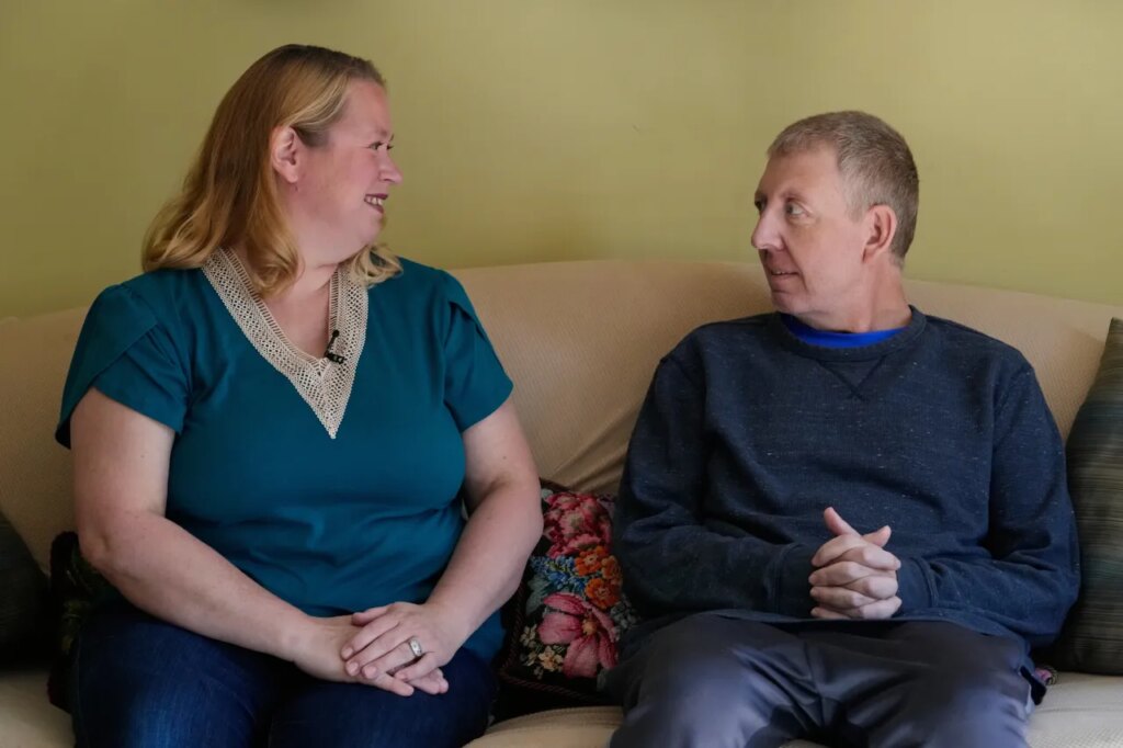 Martha Swick, left, and her husband Bill Swick look at each other at their home in Minooka, Ill., Friday, Oct. 24, 2025. (AP Photo/Nam Y. Huh)
