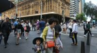 Pedestrians move along George Street on October 22, 2022 in Sydney, Australia.