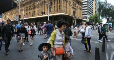 Pedestrians move along George Street on October 22, 2022 in Sydney, Australia.