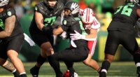 Oregon quarterback Dante Moore (5) is sacked by Wisconsin linebacker Mason Reiger (22) during the first half of an NCAA college football game Saturday, Oct. 25, 2025, in Eugene, Ore. (AP Photo/Lydia Ely)
