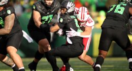 Oregon quarterback Dante Moore (5) is sacked by Wisconsin linebacker Mason Reiger (22) during the first half of an NCAA college football game Saturday, Oct. 25, 2025, in Eugene, Ore. (AP Photo/Lydia Ely)