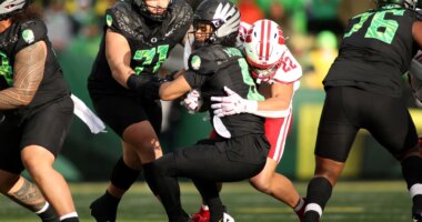 Oregon quarterback Dante Moore (5) is sacked by Wisconsin linebacker Mason Reiger (22) during the first half of an NCAA college football game Saturday, Oct. 25, 2025, in Eugene, Ore. (AP Photo/Lydia Ely)