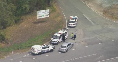 An aerial shot of multiple police cars on a road in QLD.